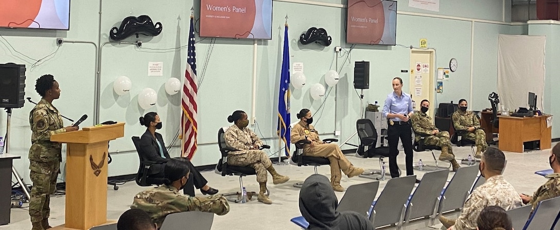 Office of Special Investigations Special Agent Brandi Cook, of Detachment 242, Ali Al Salem Air Base, Kuwait, standing right, addresses attendees at the Al Jabar Air Base, Kuwait, Diversity and Inclusion Council Women's Panel discussion March 31. SA Cook is responsible for planning and coordinating criminal investigations and counterintelligence operations, conducting liaisons with counterpart law enforcement agencies and prepares investigative and intelligence reports supporting Air Force operations throughout Kuwait. (Photo by SA Sean Peterson)