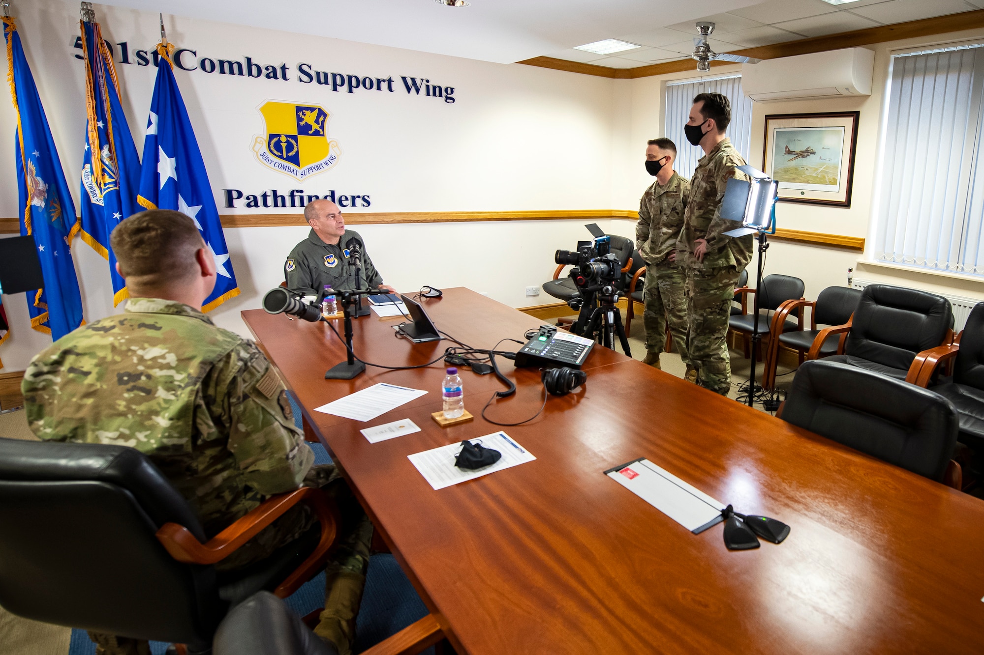 Gen. Jeff Harrigian, center, U.S. Air Forces in Europe and Air Forces Africa commander, speaks with Airmen from the 501st Combat Support Wing at RAF Alconbury, England, April 15, 2021. During his visit to the 501st CSW, Harrigian recorded a podcast with Col. Kurt Wendt, 501st CSW commander, discussing agile combat engagement as well as the Secretary of the Air Force’s plan for innovation. (U.S. Air Force photo by Senior Airman Eugene Oliver)