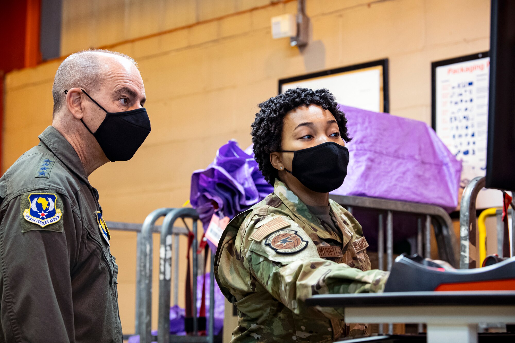 U.S. Air Force Airman 1st Class Tya Campbell, right, mail processing specialist with the U.S. Air Forces in Europe and Air Forces Africa Air Postal Squadron, Detachment Five, speaks with Gen. Jeff Harrigian, left,USAFE-AFAFRICA commander at RAF Alconbury, England, April 15, 2021. Harrigian visited the 501st Combat Support Wing to speak with and recognize Airmen from multiple squadrons across the wing. (U.S. Air Force photo by Senior Airman Eugene Oliver)