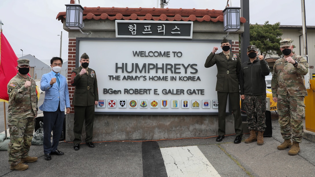 U.S. Marine Corps, U.S. Army, and Republic of Korea personnel pose with the unveiled gate after a dedication ceremony in honor of U.S. Marine Corps Brig. Gen. Robert E. Galer, a combat aviator and holder of the Nation’s highest decoration, the Medal of Honor, on Camp Humphreys, Pyeongtaek-Si, Republic of Korea, April 16, 2021. Through collaboration between U.S. Marine Corps Forces – Korea (MARFORK) and USAG Camp Humphreys, the newly named Galer Gate will be the only gate memorializing a U.S. Marine across 72 U.S. Army installations. (U.S. Marine Corps photo by Sgt. Ash McLaughlin)