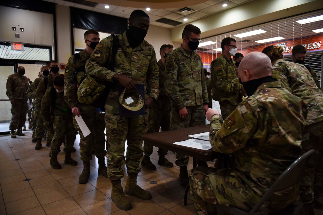 group of people signing in at a table