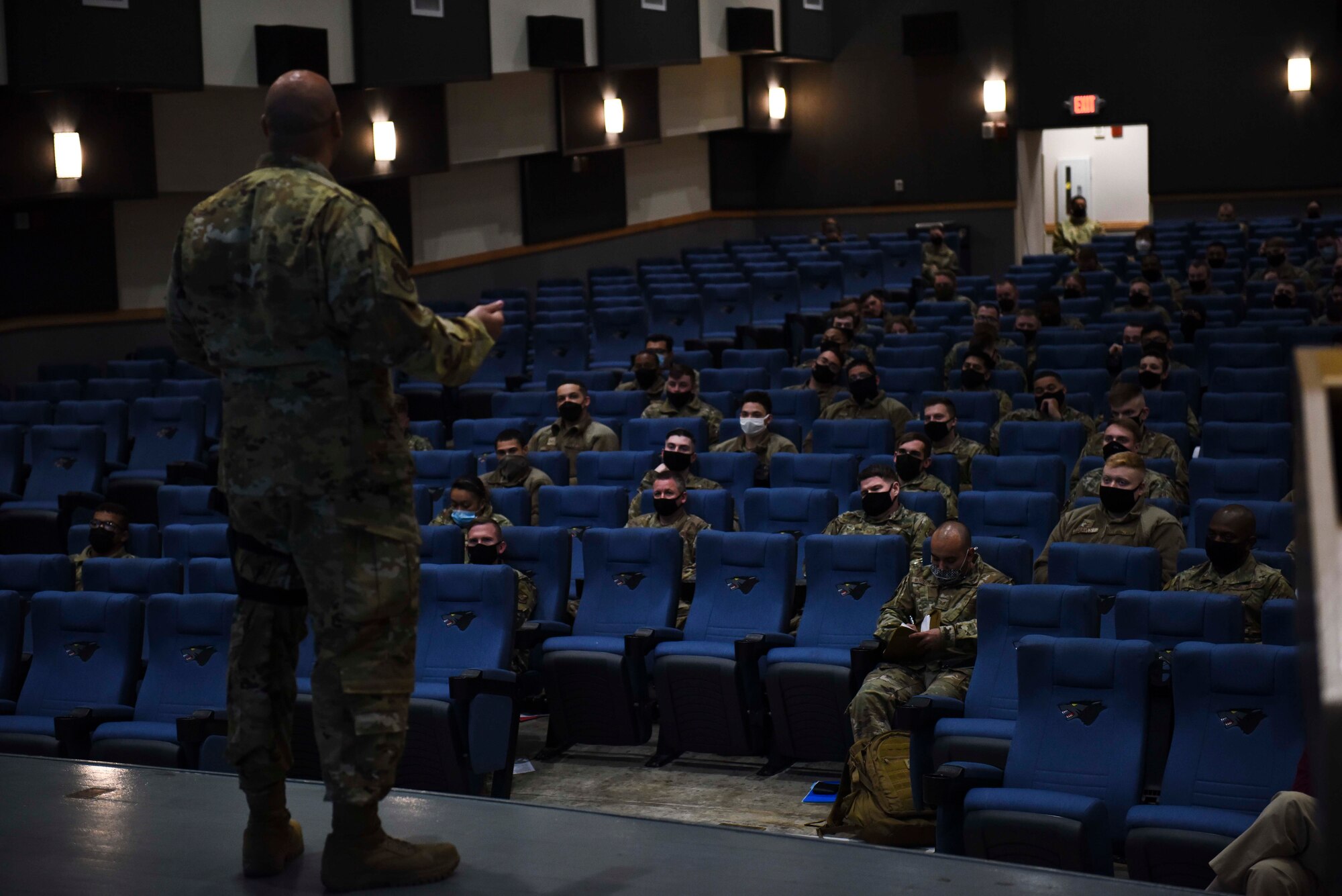 man in base theater talking to a group