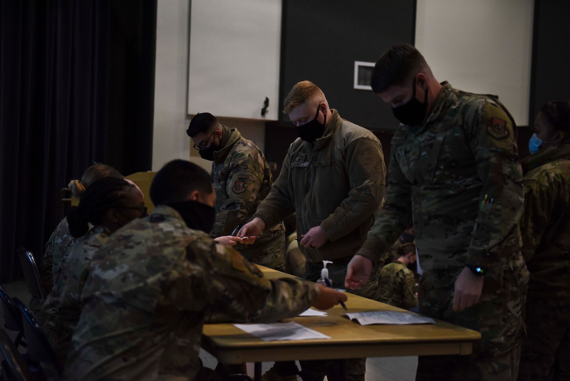 people at a table signing forms