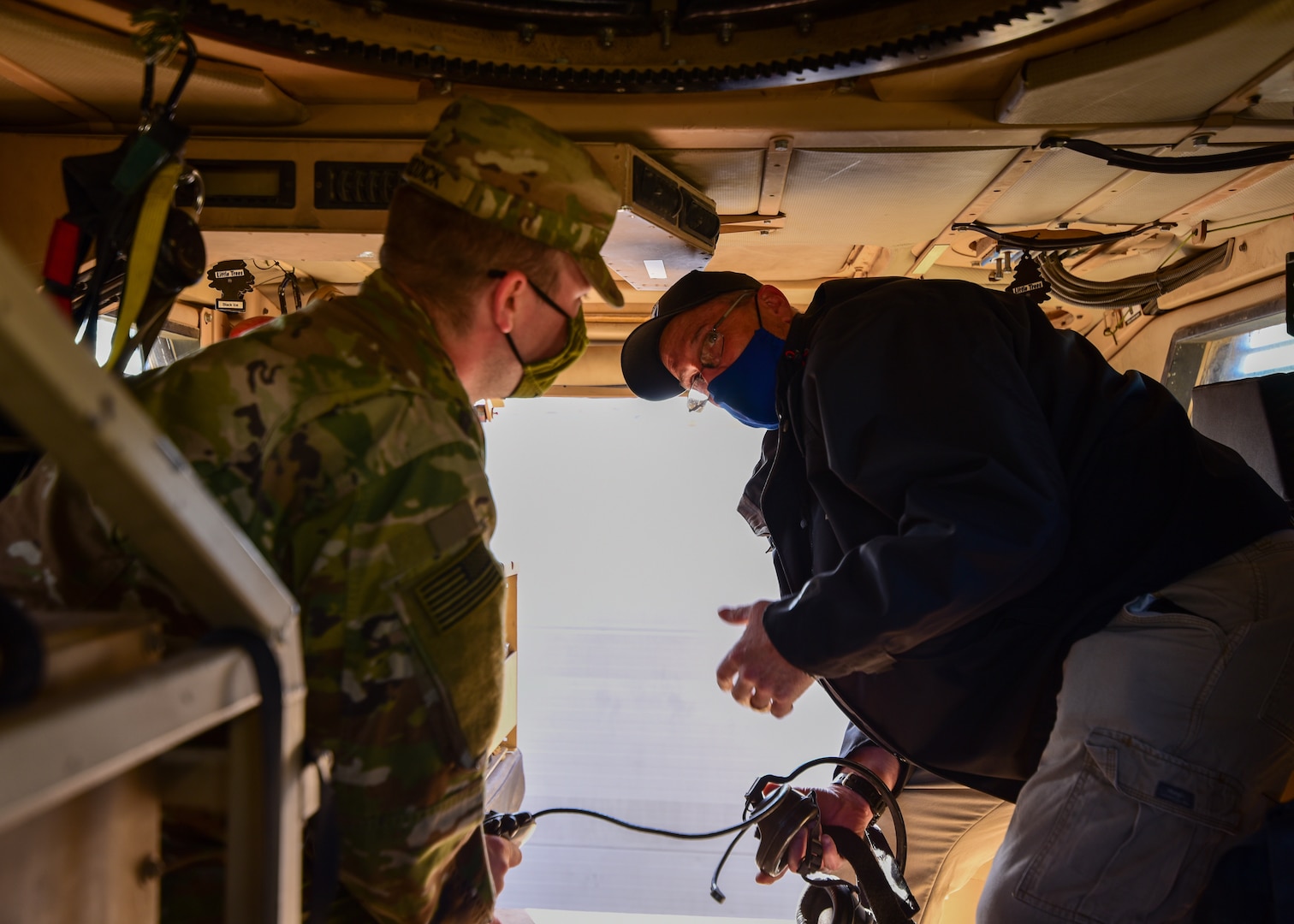 Brian L. Debutts, logistics assistance representative, 401st Army Field Support Brigade, advises Sgt. Tommy D. Riddick, U.S. Army Signal Support Systems specialist, on the proper operation of a Single Channel Ground and Airborne Radio System/ Advanced Session Initiation Protocol at Erbil Ari Base, Iraq, Feb. 23. LARs like Debutts specialize in providing technical assistance to Soldiers on everything from communications and electronics to tracked vehicles and armament.