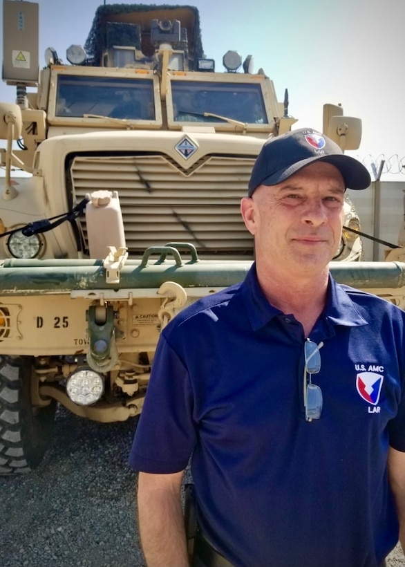 Brian L. Debutts, logistics assistance representative, 401st Army Field Support Brigade, stands by a Mine Resistant Ambush Protected (MRAP) Maxxpro at Erbil Ari Base, Iraq, Feb. 23, 2021. LARs like Debutts specialize in providing technical assistance to Soldiers on everything from communications and electronics to tracked vehicles and armament.