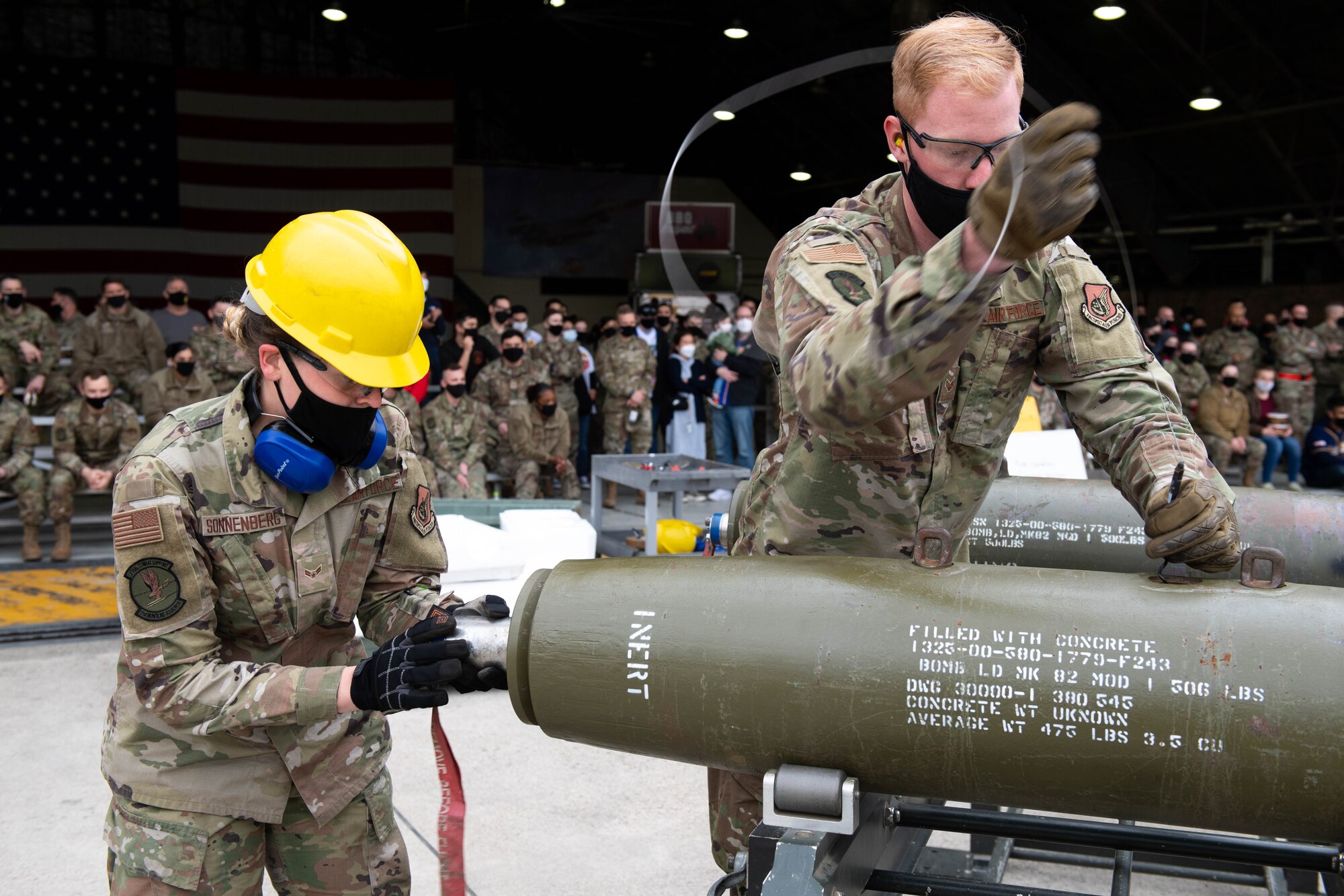 Airman 1st Class Danielle Sonnenberg (left) and Senior Airman Michael Morris, 51st Munitions Squadron, compete in the Load Crew of the Quarter Competition at Osan Air Base, Republic of Korea, April 16, 2021. This competition is held by the 51st Maintenance Group to showcase the Munitions Squadron and Aircraft  Maintenance Units while fostering healthy competition and morale. (U.S. Air Force photo by Senior Airman Kevyn Allen)
