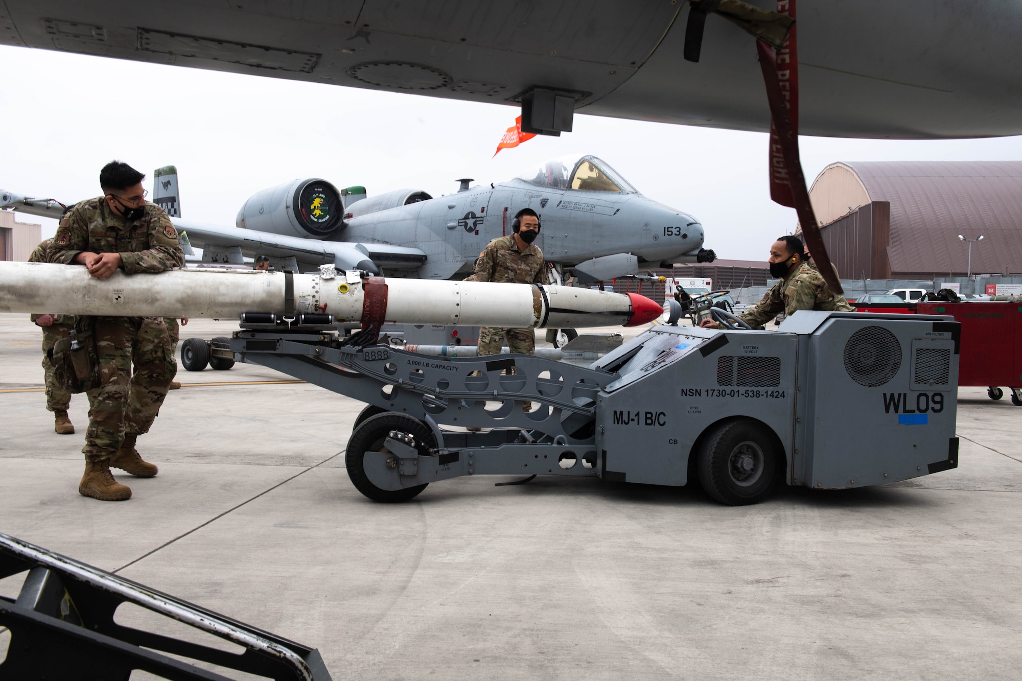 Weapons Load Crew Members from the 36th Aircraft Maintenance Unit compete in the Load Crew of the Quarter Competition at Osan Air Base, Republic of Korea, April 16, 2021. Two teams from the 36th and 25th AMU raced to load munitions onto either the A-10 Thunderbolt II or the F-16 Fighting Falcon aircraft. (U.S. Air Force photo by Senior Airman Kevyn Allen)
