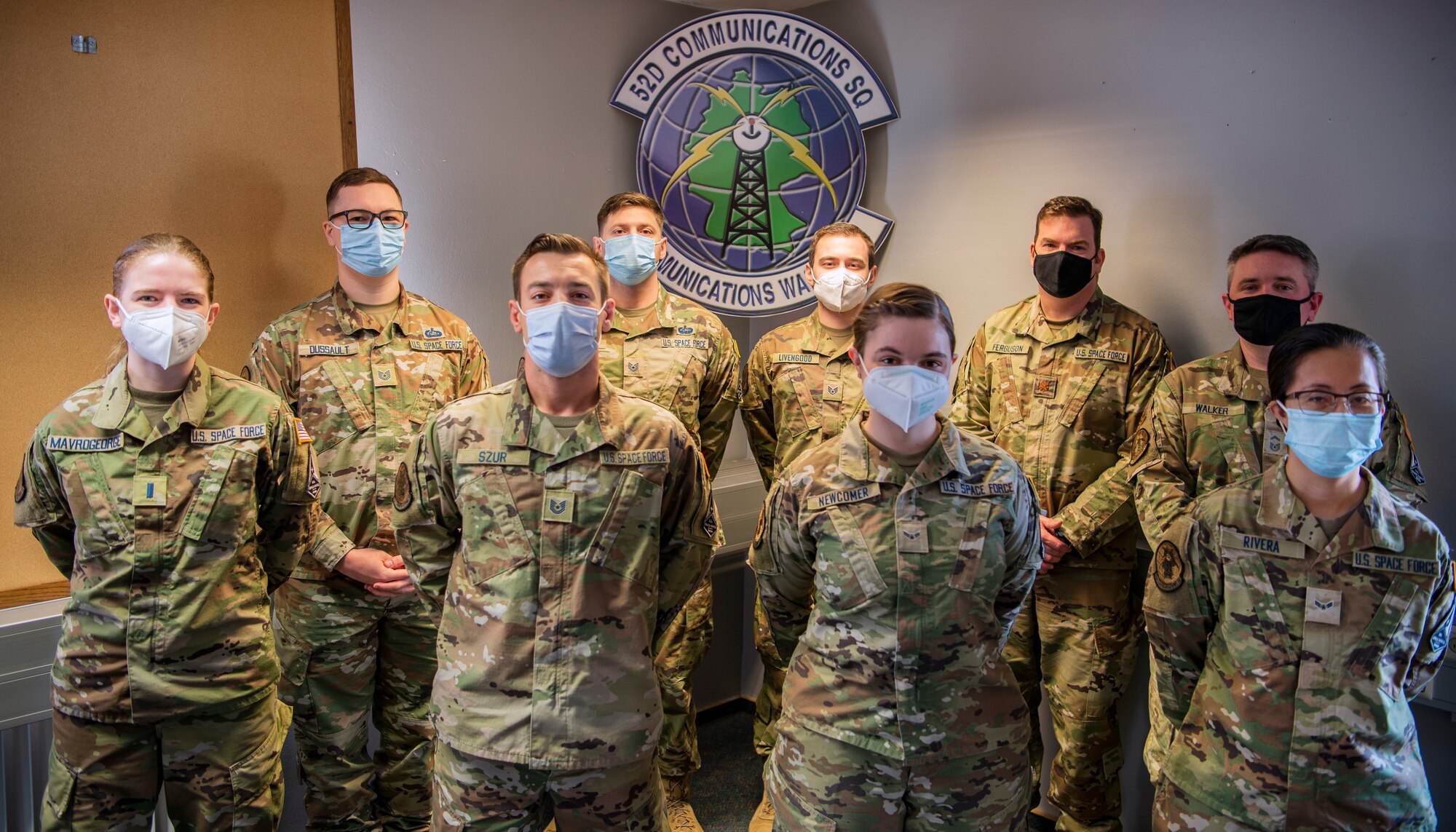 Nine U.S. Space Force Guardians pose for a group photo in the 52nd Communications Squadron heritage room, April 16, 2021.