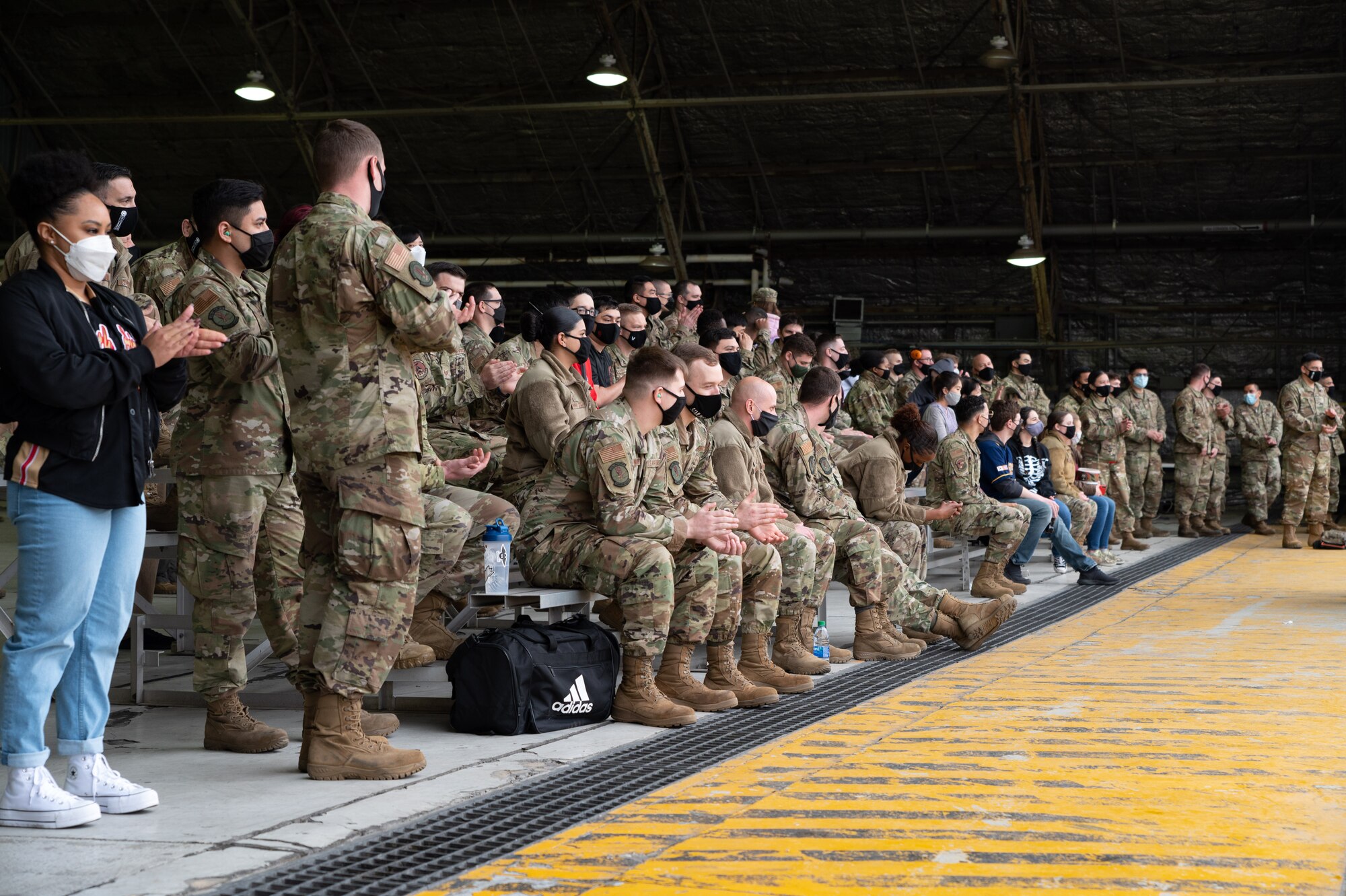 The audience applauds during the 51st Maintenance Group’s “Load Crew of the Quarter” Competition at Osan Air Base, Republic of Korea, April, 16, 2021. Two teams, representing the 25th and 36th Aircraft Maintenance Units, raced to build and load munitions onto both the A-10 Thunderbolt II and F-16 Fighting Falcon aircraft. (U.S. Air Force photo by Technical Sgt. Nicholas Alder)