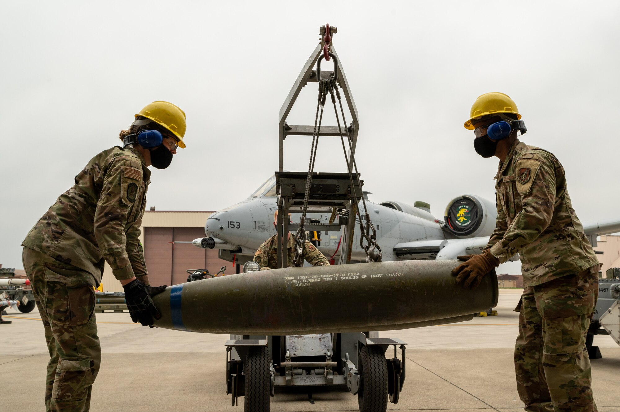 Airman 1st Class Danielle Sonnenberg (left) and Staff Sgt. Marcos Maldonado, 51st Munitions Squadron, steady ordnance during the Load Crew of the Quarter Competition at Osan Air Base, Republic of Korea, April 16, 2021. Two teams of Munitions Systems Airmen competed to build munitions the fastest. (U.S. Air Force photo by Technical Sgt. Nicholas Alder)