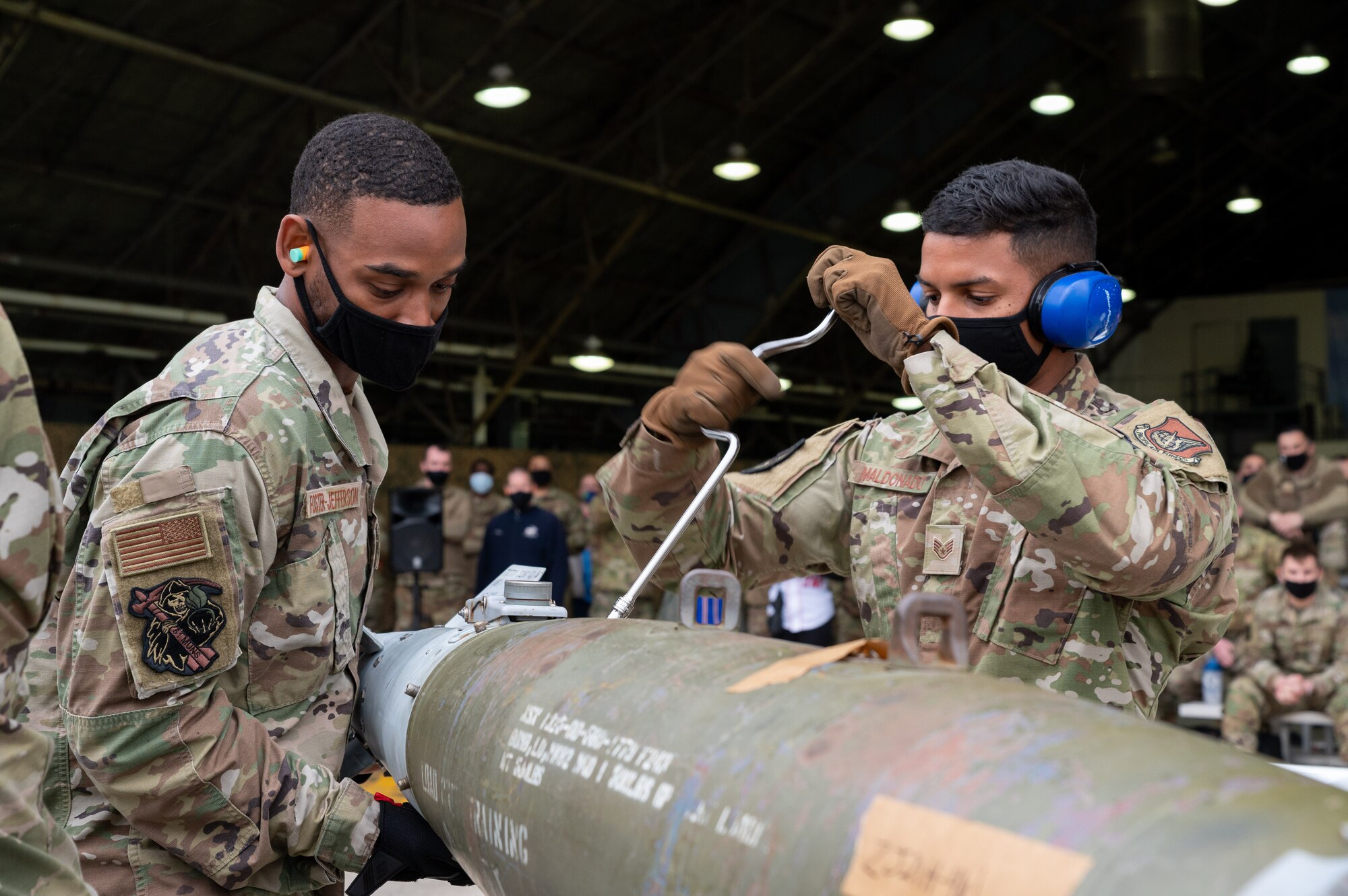 Senior Airman Khalil Foster-Jefferson (left) and Staff Sgt. Marcos Maldonado, 51st Munitions Squadron, secure bolts during the Load Crew of the Quarter Competition at Osan Air Base, Republic of Korea, April 16, 2021. Munitions Systems Airmen compete to build munitions the fastest. (U.S. Air Force photo by Technical Sgt. Nicholas Alder)