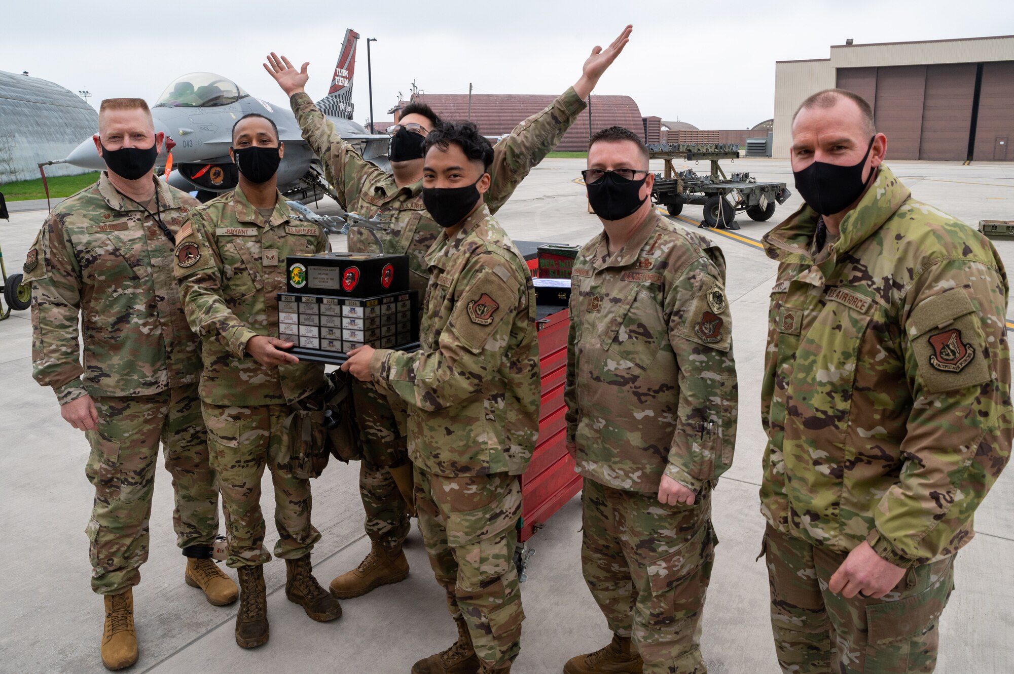 Col. Brian Moore, 51st Maintenance Group Commander (left), and Chief Master Sgt’s. James Otto and Jason Johnson, 51st Maintenance Group Superintendents (right), present Senior Airman Michael Bryant, Staff Sgt. Daniel Jimenez, and Senior Airman Ian Saure the trophy during the Load Crew of the Quarter Competition at Osan Air Base, Republic of Korea, April 16, 2021. The 36th Aircraft Maintenance Unit took home the trophy this quarter. (U.S. Air Force photo by Technical Sgt. Nicholas Alder)
