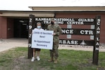 Maj. Michael Billings, Kansas Training Center battalion executive officer, and Hayley Samford, marketing and community outreach associate with the Salina Family Healthcare Center, advertise the COVID-19 vaccine clinic held at the Kansas National Guard Training Center April 15, 2021. The clinic teamed with the Kansas Guard because of the ideal location of its facilities to serve the west side of town.