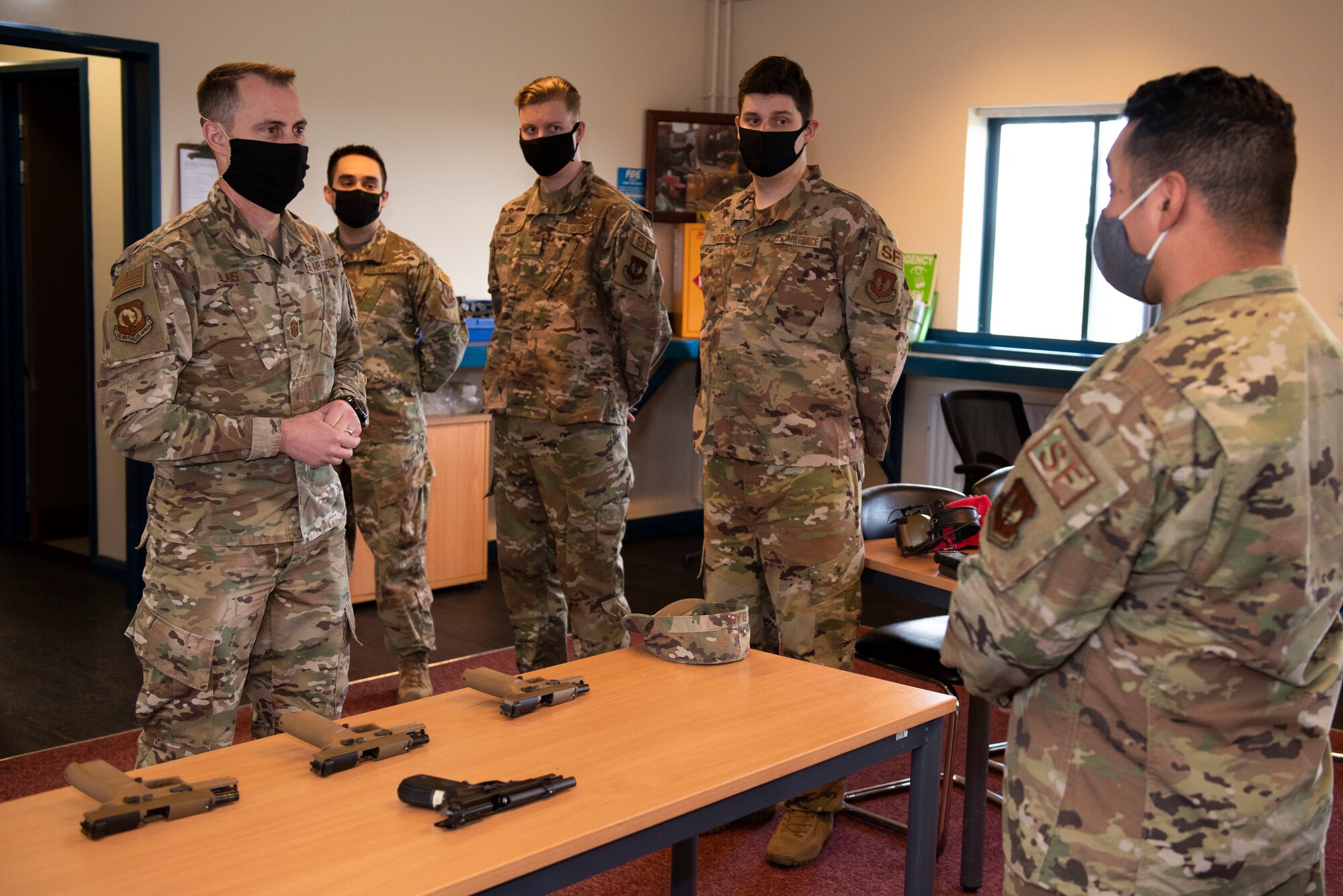 U.S. Air Force Staff Sgt. Matthew Hurtado, right, 423rd Security Forces Squadron combat arms instructor, briefs Chief Master Sgt. Brion Blais, left, U.S. Air Forces in Europe and Air Forces Africa command chief, at the combat arms firing range during a visit to the 501st Combat Support Wing at Royal Air Force Molesworth, England, April. 15, 2021. The USAFE-AFAFRICA command team visited the 501st CSW to engage with Airmen and recognize outstanding performers. (U.S. Air Force photo by Senior Airman Jennifer Zima)
