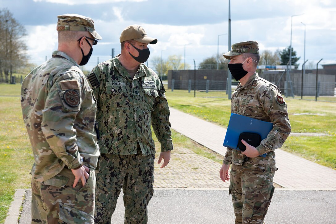 U.S. Air Force Chief Master Sgt. Brion Blais, right, U.S. Air Forces in Europe and Air Forces Africa command chief, greets U.S. Air Force Col. Abraham Jackson, left, and U.S. Navy Master Chief Petty Officer Edward Pruitt, center, U.S. European Command Joint Intelligence Operations Center Europe Analytic Center senior enlisted leader, during a USAFE-AFAFRICA command team visit to the 501st Combat Support Wing USEUCOM JIOCEUR Analytic Center at Royal Air Force Molesworth, England, April. 15, 2021. The USAFE-AFAFRICA command team visited the 501st CSW to engage with Airmen and recognize outstanding performers. (U.S. Air Force photo by Senior Airman Jennifer Zima)