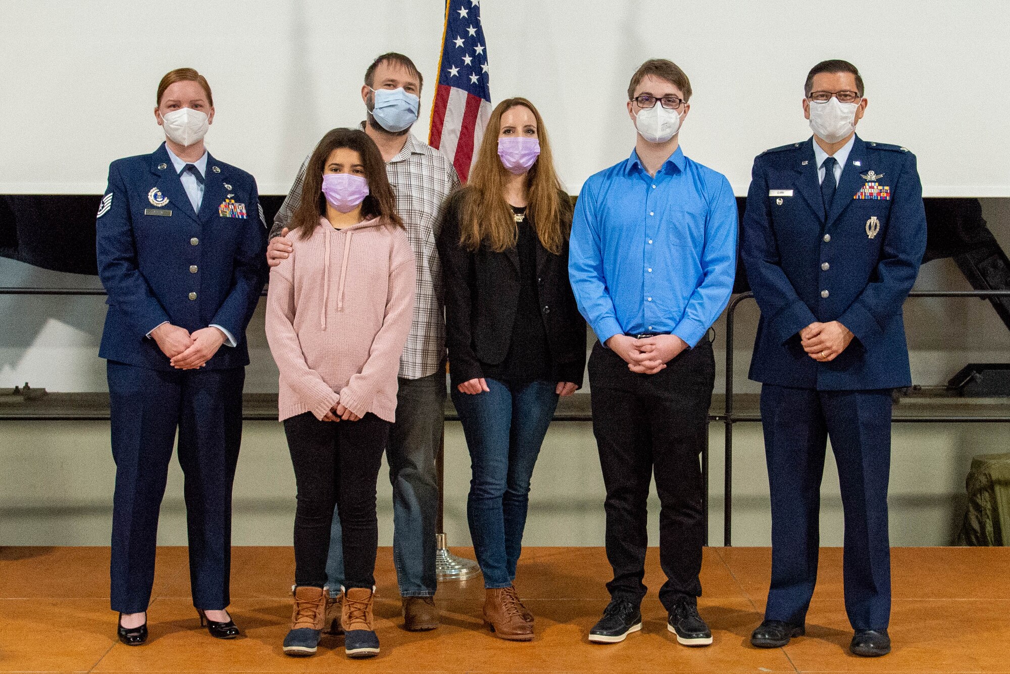 Six people stand and pose for a photo