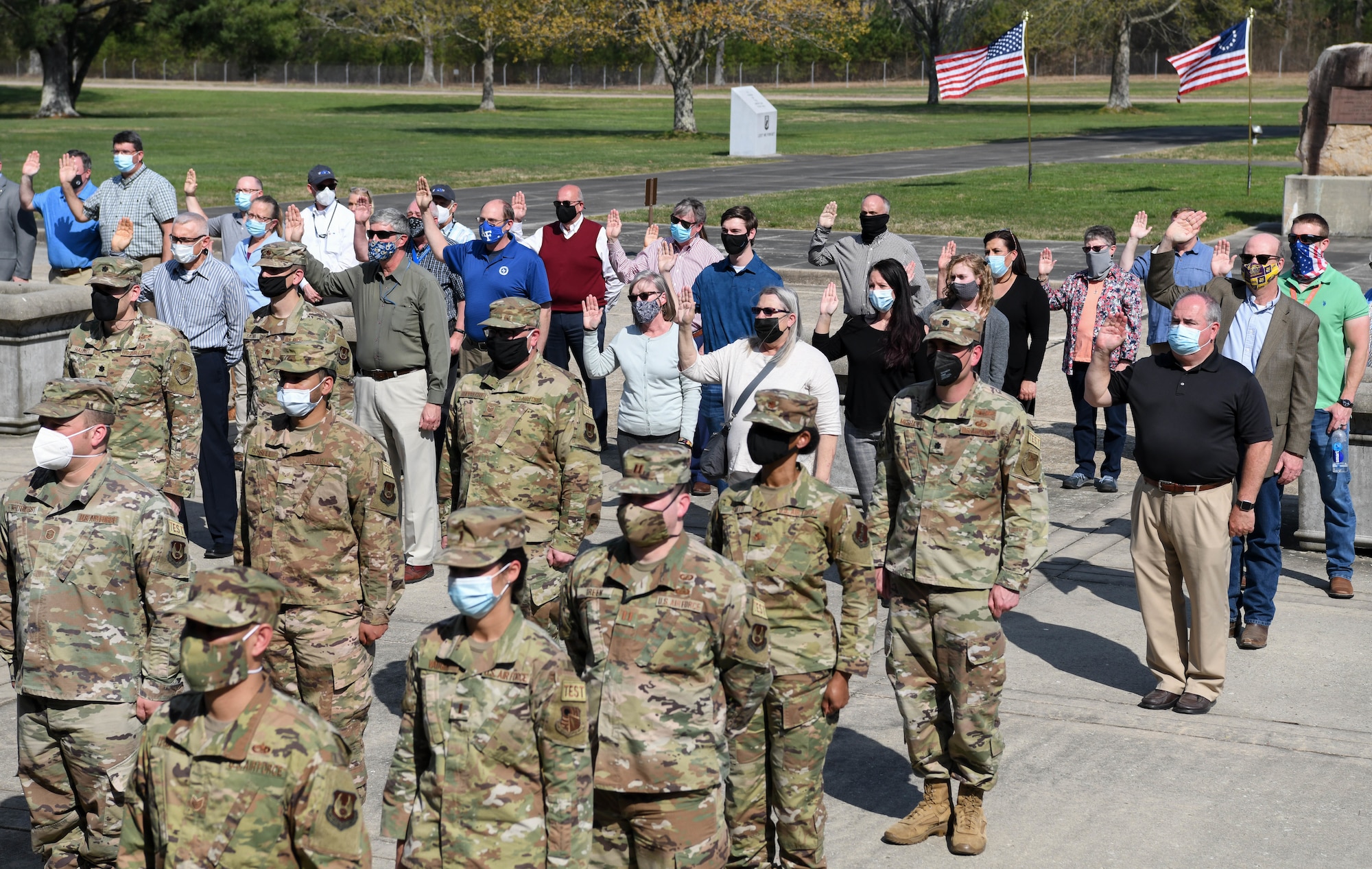 Department of Defense civilian employees reaffirm their oath of office during a flag retreat ceremony to mark the completion of the Extremism Stand Down exercises, April 6, 2021, at Arnold Air Force Base, Tenn. The importance of the oath of office was a focus of the stand down. (U.S. Air Force photo by Jill Pickett)
