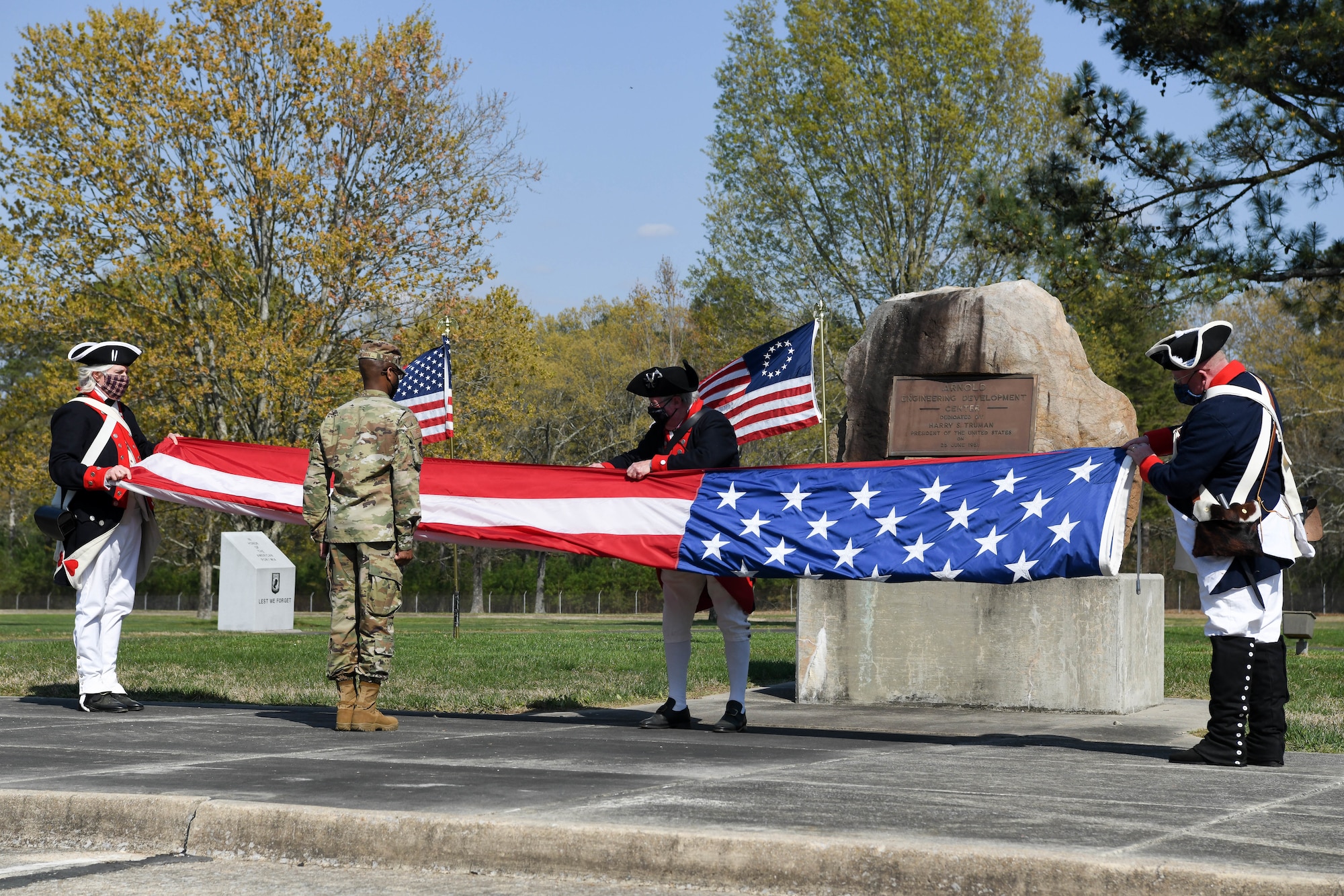 Master Sgt. Don Wilson, assists members of the Tennessee Society of the Sons of the American Revolution, from left, Doug Dickerson, Jerry Hjellum and Cliff Kent, fold the flag during a flag retreat ceremony held to mark the end of Extremism Stand Down exercises, April 6, 2021, at Arnold Air Force Base, Tenn. (U.S. Air Force photo by Jill Pickett)