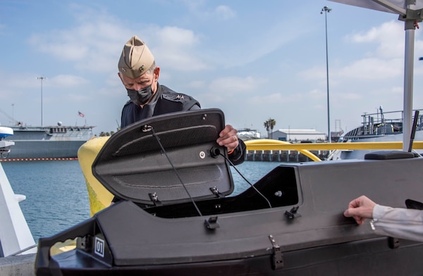 Chief of Naval Research, Rear Adm. Lorin Selby, observes an unmanned vessel on Pier 12 during Integrated Battle Problem 21 (UxS IBP 21) Distinguished Visitors day at Naval Base San Diego.