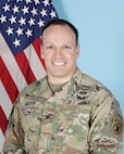 man standing in front of two flags,