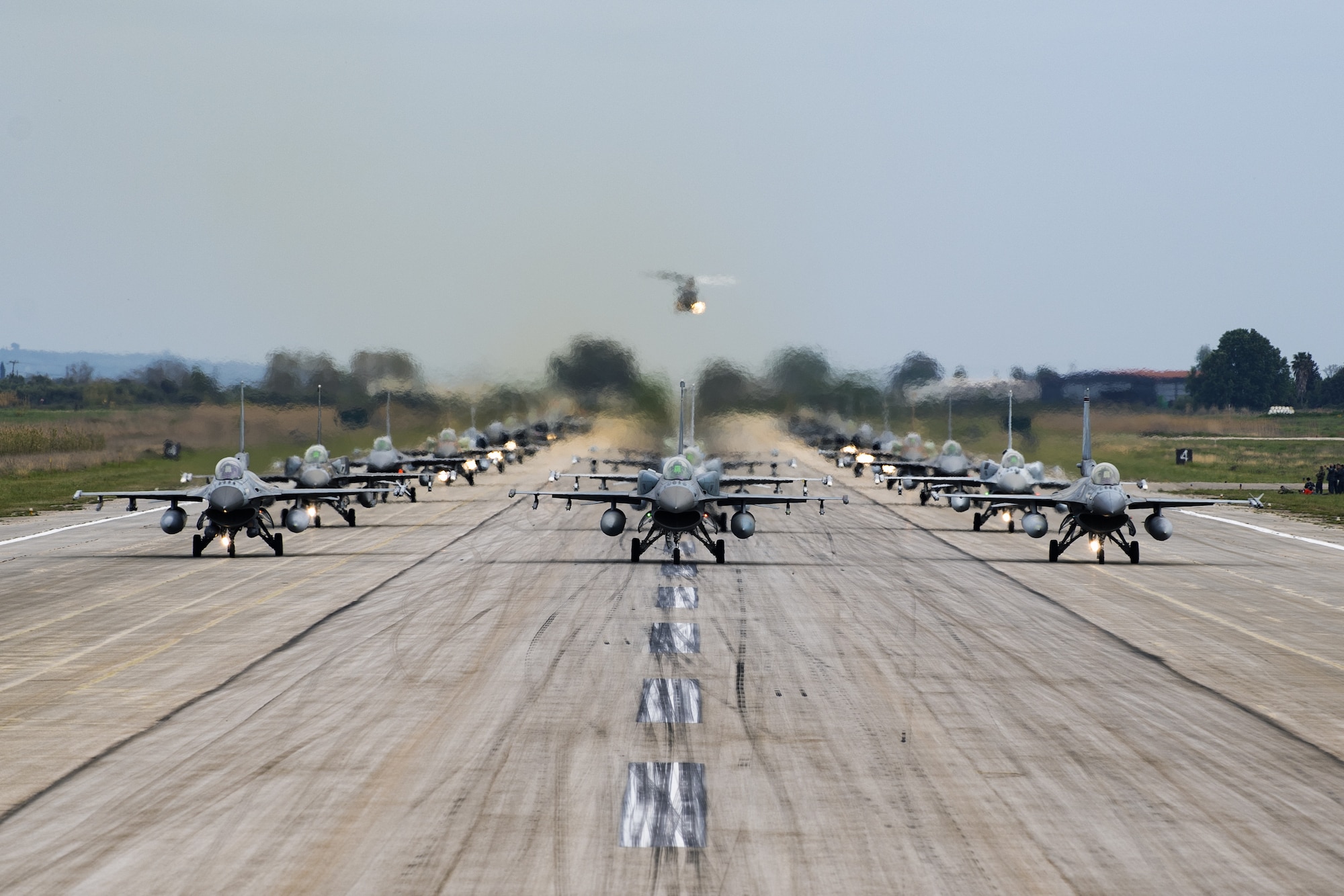 Aircraft from several countries participating in INIOCHOS 21 perform an elephant walk at Andravida Air Base, Greece, April 18, 2021. The 510th Fighter Squadron participated in INIOCHOS 21, a Hellenic air force-led, large force flying exercise. Participation in INIOCHOS 21 allowed U.S. Air Force pilots the opportunity to develop and improve air readiness and interoperability with allied and partner air forces. (U.S. Air Force photo by Airman 1st Class Thomas S. Keisler IV)