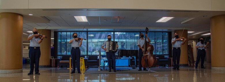 The Air Force Strings have performed monthly in several areas of the Walter Reed National Military Medical Center since 2019, but due to COVID-19, their mission took a hiatus. The Strings were invited to return in July of 2020 and were the first group to provide live music since the beginning of the pandemic. (Photo by Mass Communications Specialist 2nd Class Kurtis A. Hatcher)
