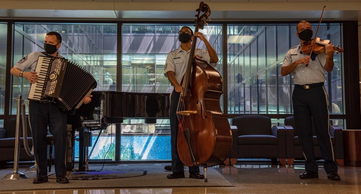 Senior Master Sgt. Frank Busso, accordion, and Technical Sgt. Victor Holmes, bass, make up the heartbeat of the Strolling Strings ensemble. (Photo by Mass Communications Specialist 2nd Class Kurtis A. Hatcher)