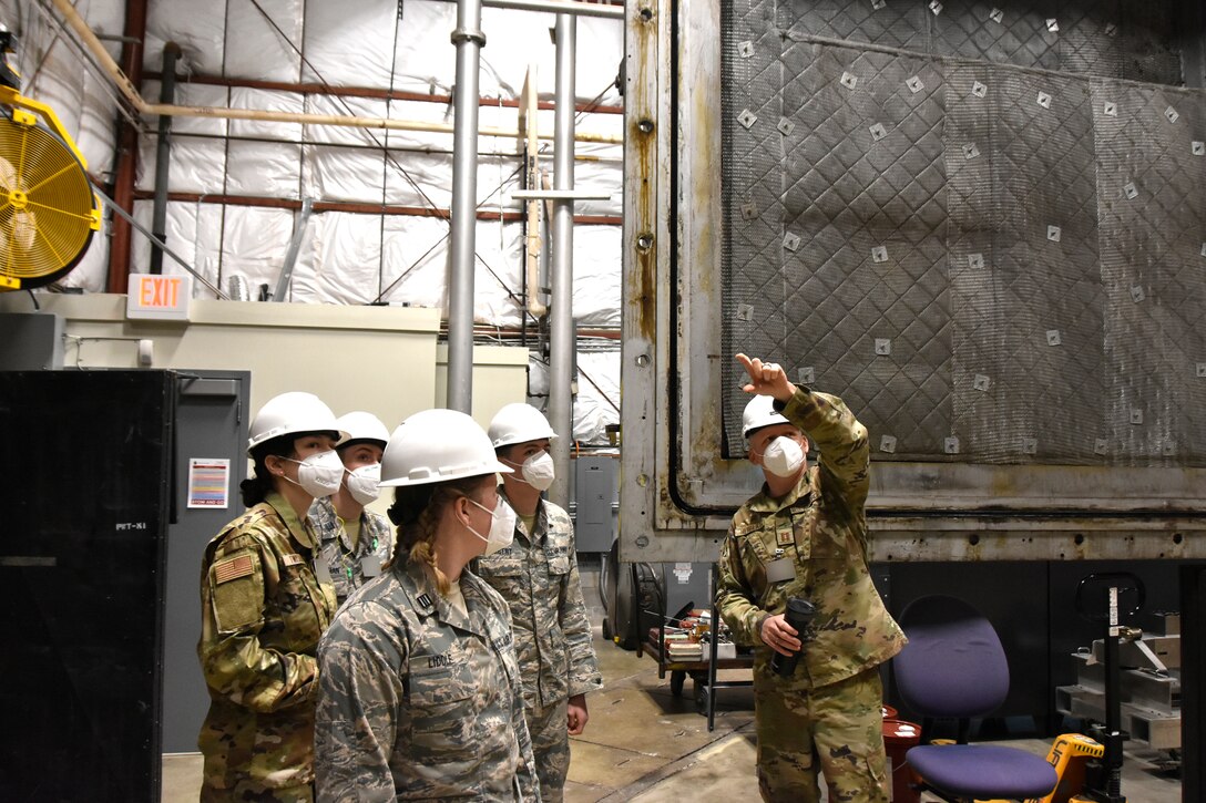 Capt. Michael Herbert, a test manager in the Arnold Engineering Development Complex Aerodynamics Test Branch at Arnold Air Force Base, right, describes 4-foot transonic wind tunnel operations, March 19, 2021, to cadets with Air Force ROTC Detachment 290 from the University of Kentucky. The cadets, pictured from left, are Dillyn Twisdale, Andrew Kauffman, Olivia Liddle and Dominick Herbert. (U.S. Air Force photo by Bradley Hicks) (This image was altered by obscuring badges for security purposes.)