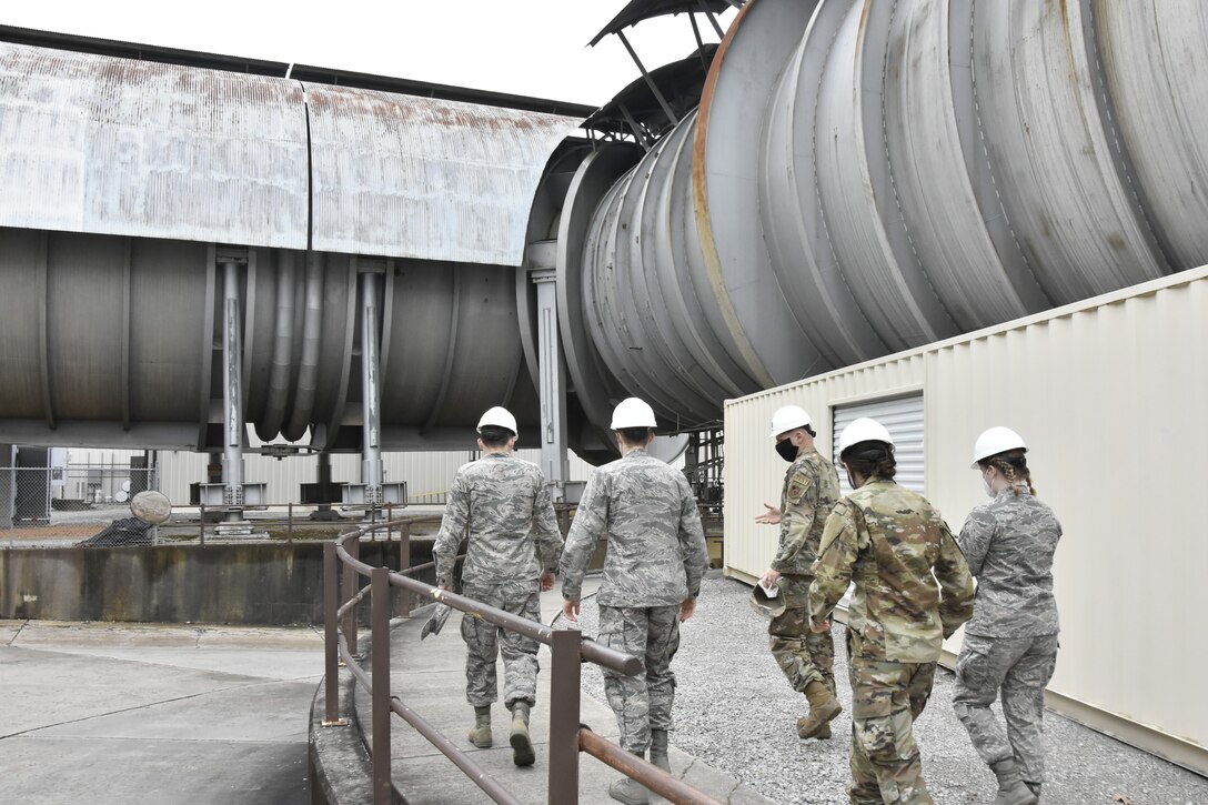 Capt. Michael Herbert, a test manager in the Arnold Engineering Development Complex Aerodynamics Test Branch at Arnold Air Force Base, center, leads cadets with Air Force ROTC Detachment 290 from the University of Kentucky on a tour of AEDC Propulsion Wind Tunnel facilities at Arnold, March 19, 2021. The cadets visited Arnold last month to complete required Professional Development Training. (U.S. Air Force photo by Bradley Hicks)