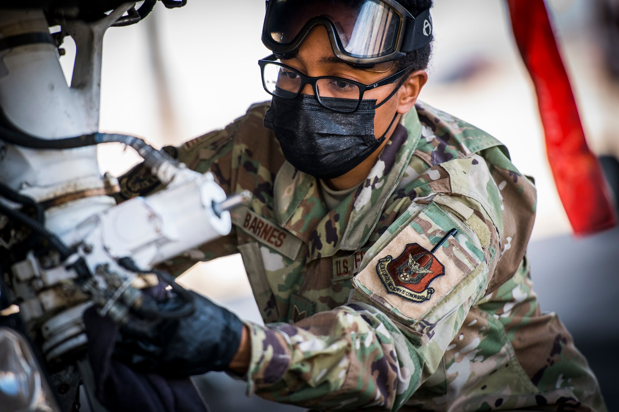 Tech. Sgt. Amber Barnes, 926th Aircraft Maintenance Squadron avionics technician applies cleaning applicant to the F-16 during a training exercise, April 10, 2021 at Nellis Air Force Base, Nev. The 926th AMXS conducted an operations exercise to maintain steadfast readiness that relate to real world day-to-day functions.