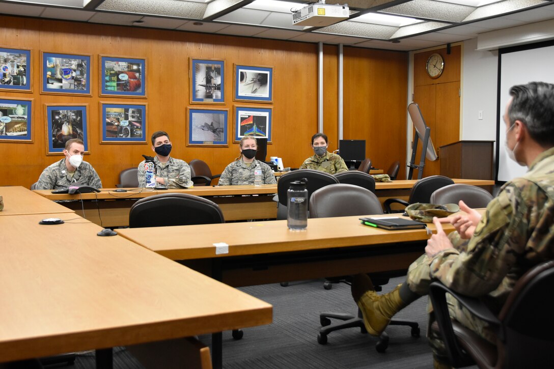 Lt. Col. Lane Haubelt, chief of the Arnold Engineering Development Complex Propulsion Test Branch at Arnold Air Force Base, right, answers questions from cadets with Air Force ROTC Detachment 290 from the University of Kentucky during a mentoring session March 19, 2021. The cadets visited Arnold last month to complete required Professional Development Training. While at Arnold, they toured base facilities and spoke with Arnold personnel to help better prepare them for their own future Air Force careers. The cadets, pictured from left, are Andrew Kauffman, Dominick Herbert, Olivia Liddle and Dillyn Twisdale. (U.S. Air Force photo by Bradley Hicks) (This image was altered by obscuring badges for security purposes.)