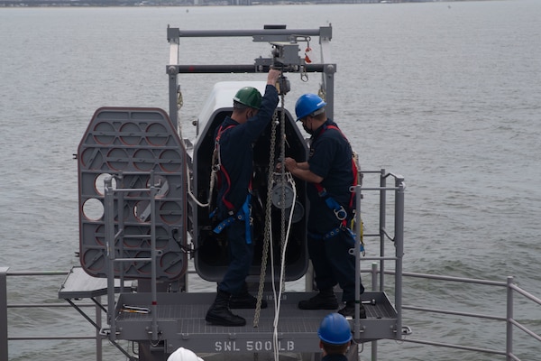 Sailors assigned to the aircraft carrier USS Gerald R. Ford (CVN 78), remove a RIM-116 missile from the ship's aft rolling airframe missile mount in preparation for combat systems ship qualification trials (CSSQT).