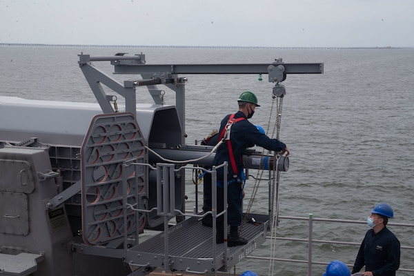 Sailors assigned to the aircraft carrier USS Gerald R. Ford (CVN 78), remove a RIM-116 missile from the ship's aft rolling airframe missile mount in preparation for combat systems ship qualification trials (CSSQT).