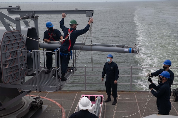 Sailors assigned to the aircraft carrier USS Gerald R. Ford (CVN 78), remove a RIM-116 missile from the ship's aft rolling airframe missile mount in preparation for combat systems ship qualification trials (CSSQT).