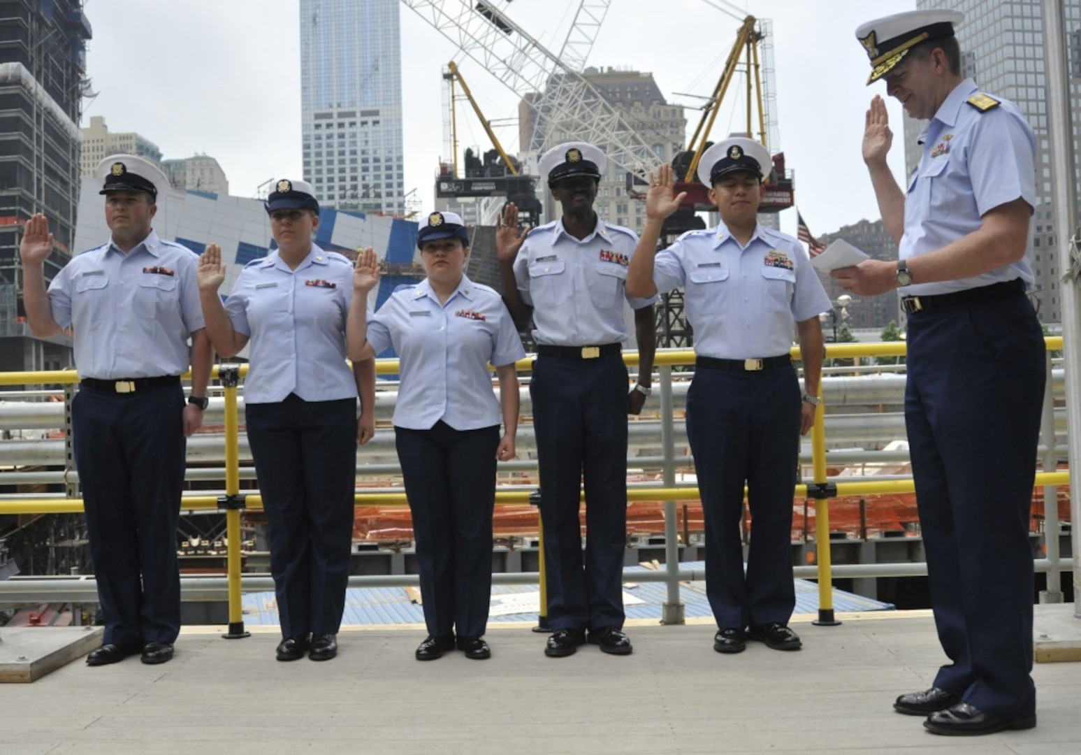 NEW YORK - Coast Guard Petty Officers, from left, Stephen Miller, Heather Clark, Paola Colon, Marc-Antoine Jean and Chief Petty Officer Hugo Gaytan, all of Coast Guard Sector New York, recite the oath of enlistment, as Vice Adm. Robert Parker, Commander of the Coast Guard's Atlantic Area, officiates the ceremony. The re-enlistment took place at the New York World Trade Center ceremonial platform, Thurs., May 26, 2011. The ceremony was part of New York Fleet Week, a week-long event in which mariners from around the world are celebrated in a series of maritime-oriented events. U.S. Coast Guard photo by Petty Officer 1st Class Thomas McKenzie