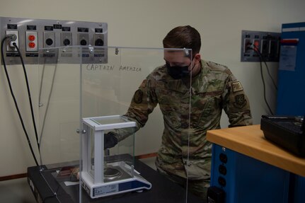 U.S. Air Force Staff Sgt. Chase Lovelace a test measurement and diagnostic equipment (TMDE) technician , calibrates a set of weights on a high accuracy balance scale at Joint Base Charleston, S.C. April 12, 2021. Test measurement and diagnostic equipment is used to accurately measure, calibrate, and test equipment or tools that might need repair.