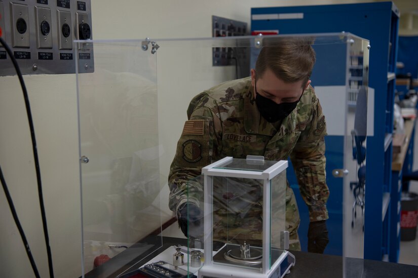 U.S. Air Force Staff Sgt. Chase Lovelace a test measurement and diagnostic equipment (TMDE) technician , calibrates a set of weights on a high accuracy balance scale at Joint Base Charleston, S.C. April 12, 2021. Test measurement and diagnostic equipment is used to accurately measure, calibrate, and test equipment or tools that might need repair.