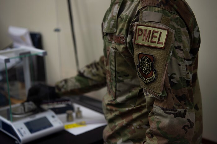 U.S. Air Force Staff Sgt. Chase Lovelace a test measurement and diagnostic equipment (TMDE) technician , calibrates a set of weights on a high accuracy balance scale at Joint Base Charleston, S.C. April 12, 2021. Test measurement and diagnostic equipment is used to accurately measure, calibrate, and test equipment or tools that might need repair.