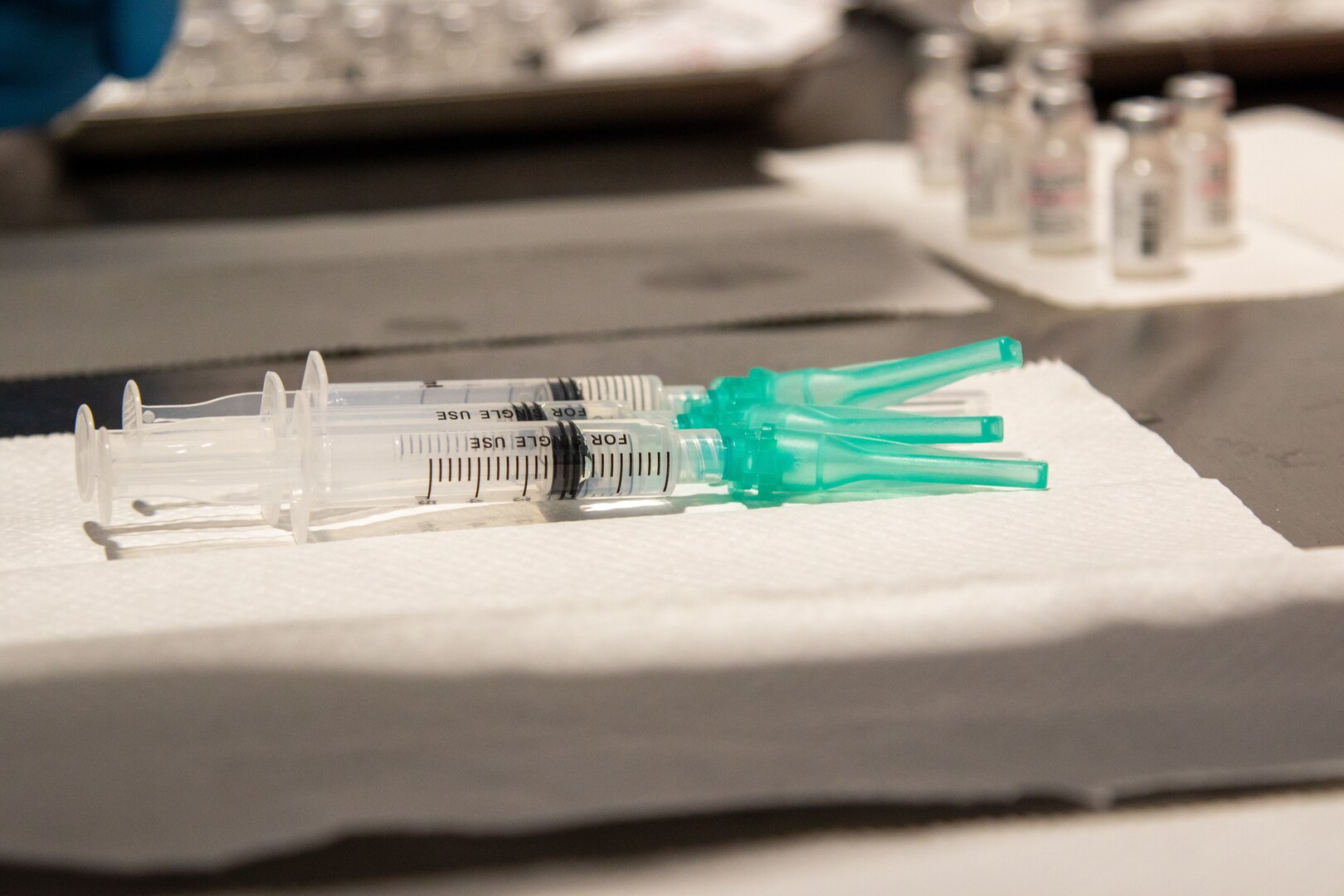 Three syringes sit on a table