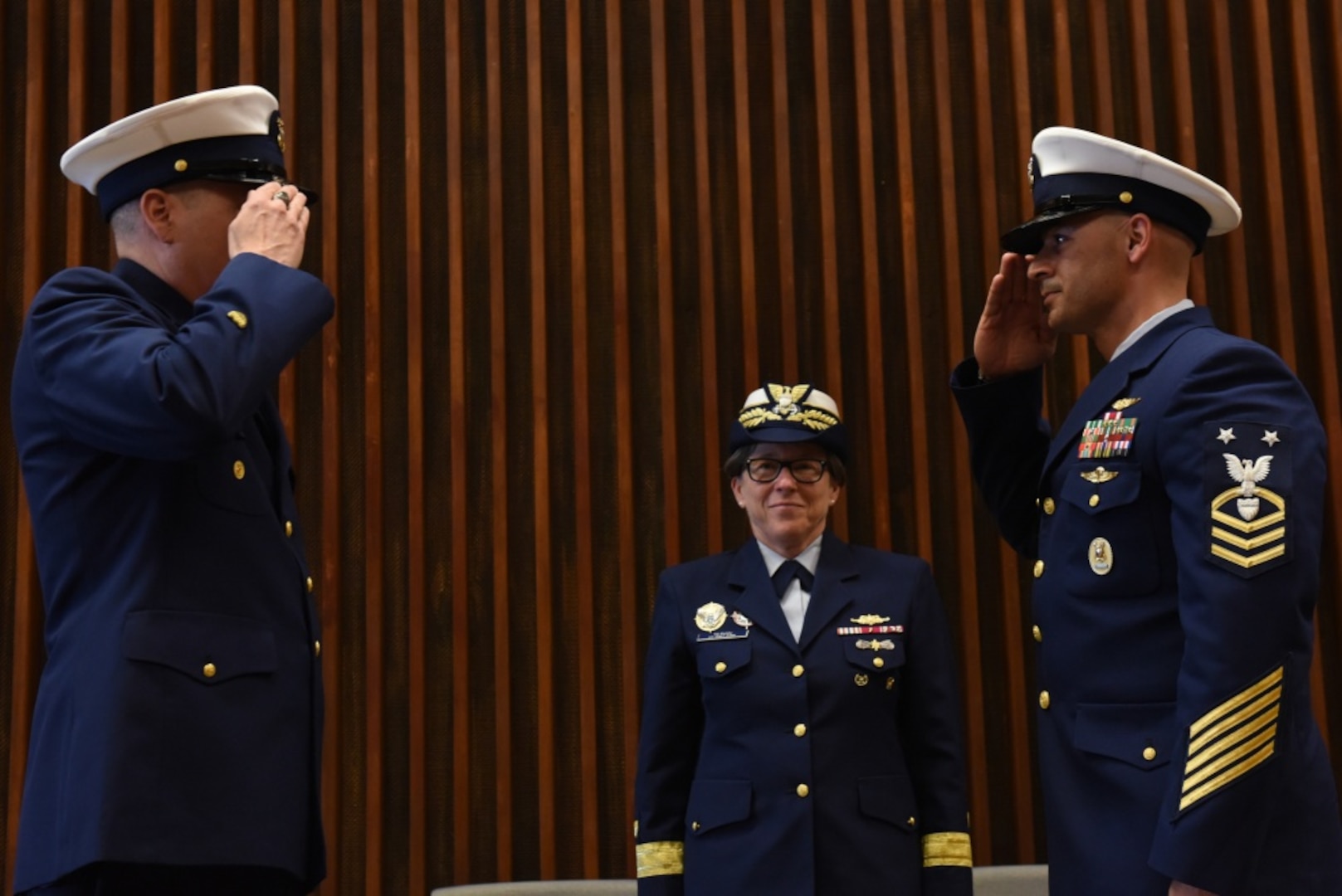 Command Master Chief Petty Officer James Bach passes the watch to Master Chief Petty Officer Jahmal Pereira during the Ninth Coast Guard District's change-of-watch ceremony in Cleveland, June 6, 2018. The ceremony was presided over by the Commander of the Coast Guard's Ninth District, Rear Adm. Joanna Nunan.