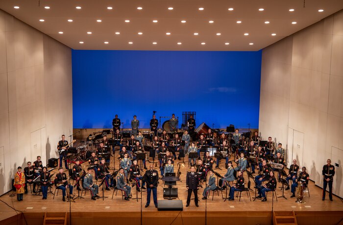 U.S. Marines with the III Marine Expeditionary Force and members of the Japan Ground-Self Defense Force 15th Brigade bands pose for a photo at Tedako Hall in Urasoe, Okinawa, Japan, April 16, 2021. The bands' harmonious performance was a display of the III MEF and 15th Brigade bands' alliance and unity within the musical arts. The annual concert was performed virtually and the recording will debut on social media platforms within the coming weeks.