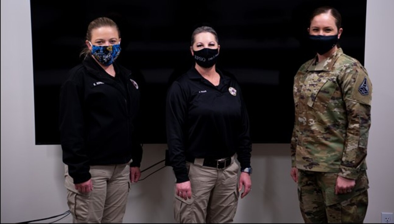 Three individuals posing for a photo