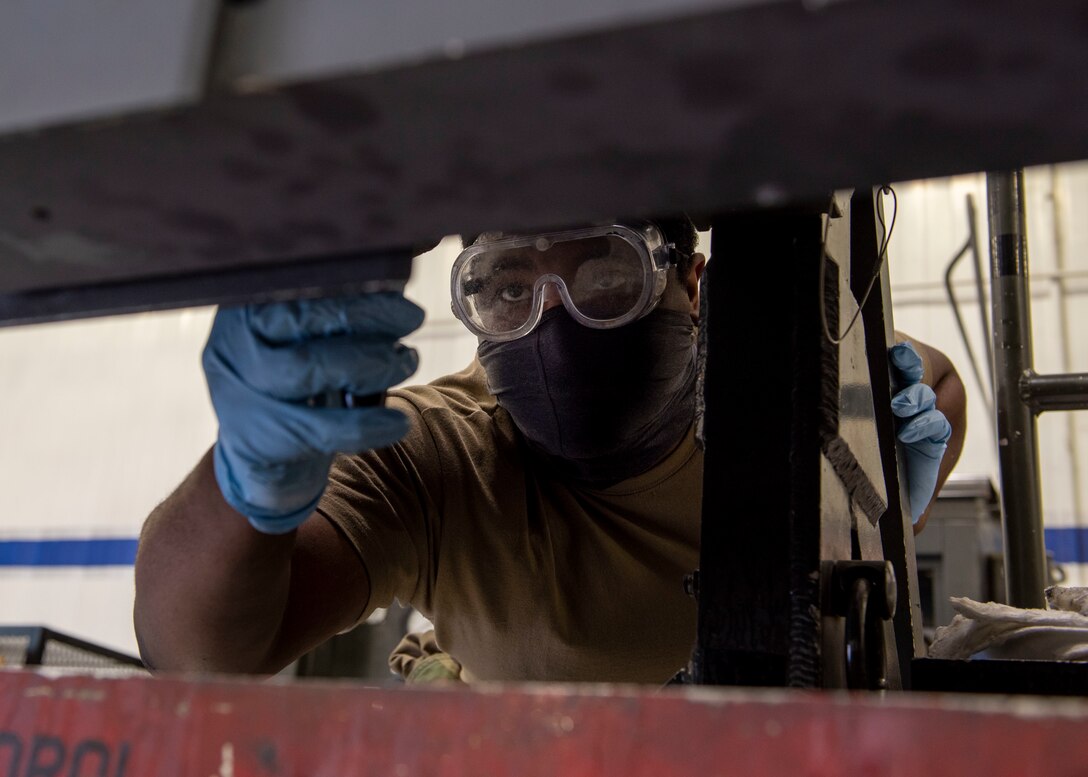 Senior Airman Demetrius Young, 4th Component Maintenance Squadron fuels systems technician, drains an F-15E Strike Eagle conformal fuel tank at Seymour Johnson Air Force Base, North Carolina, April 13, 2021.