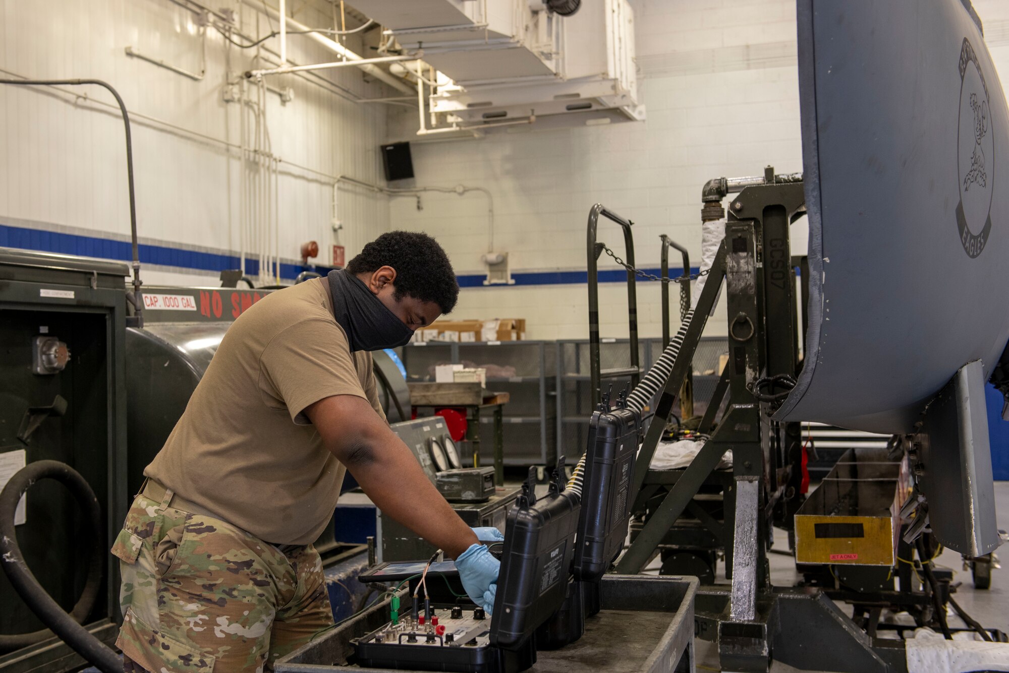 Senior Airman Demetrius Young, 4th Component Maintenance Squadron fuels systems technician, utilizes a device to measure fuel quality transmitters of an F-15E Strike Eagles conformal fuel tank at Seymour Johnson Air Force Base, North Carolina, April 13, 2021.