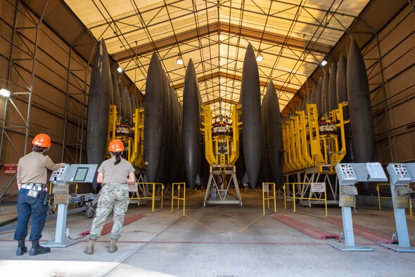 Senior Airman Mercedes Zanath, right, and Staff Sgt. Cassandra Berthold, 4th Component Maintenance Squadron fuels systems technicians, lower an F-15E Strike Eagle external fuel tank at Seymour Johnson Air Force Base, North Carolina, April 13, 2021.