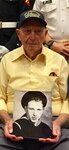 Mr. Ken Potts, one of only two living survivors that were aboard the battleship USS Arizona (BB39) holds a picture of himself when he was in the US. Navy.