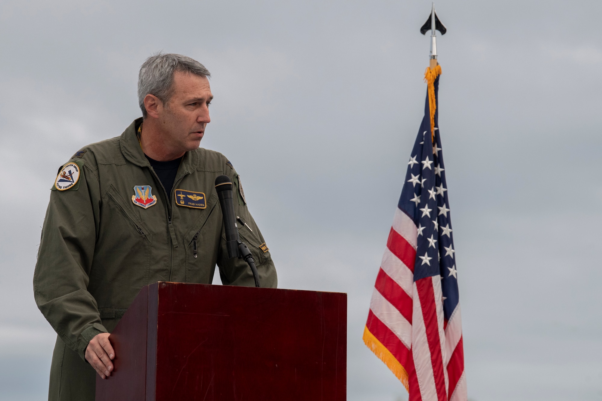 A photo of an Airman standing at a podium.