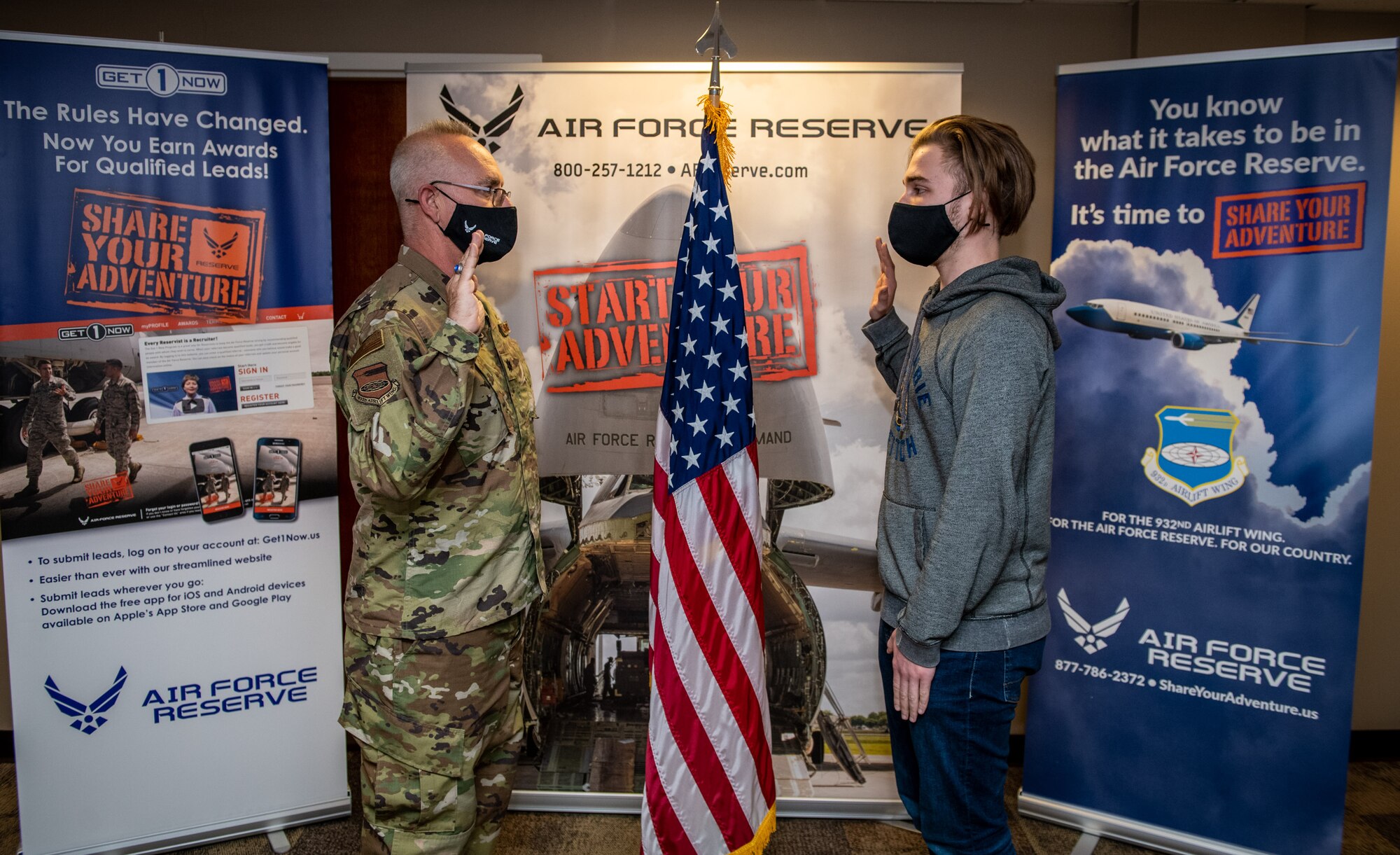 Bryce Ossman, newest recruit to join the 932nd Airlift Wing, recites the oath of enlistment given by Lt. Col. Stan Paregien, 932nd Airlift Wing Public Affairs Officer, during an enlistment ceremony, April 8, 2021, at the 932nd AW Headquarters building, Scott Air Force Base, Illinois. (U.S. Air Force photo by Christopher Parr)