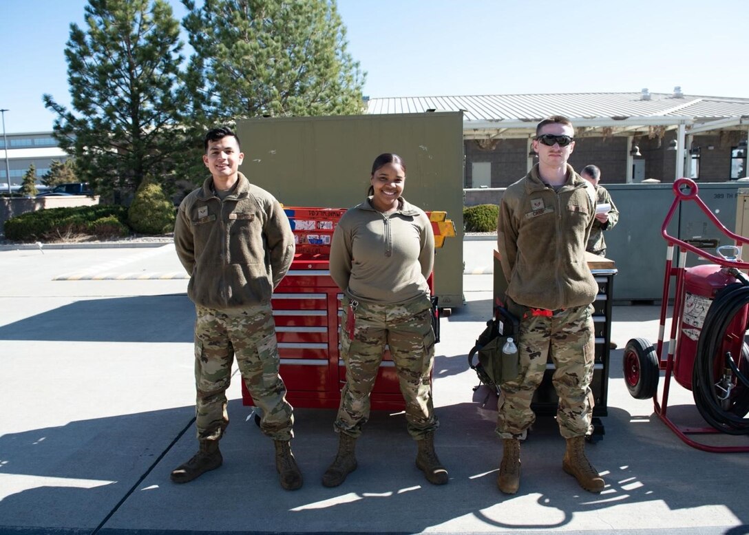 Three Airmen pose for a photo.