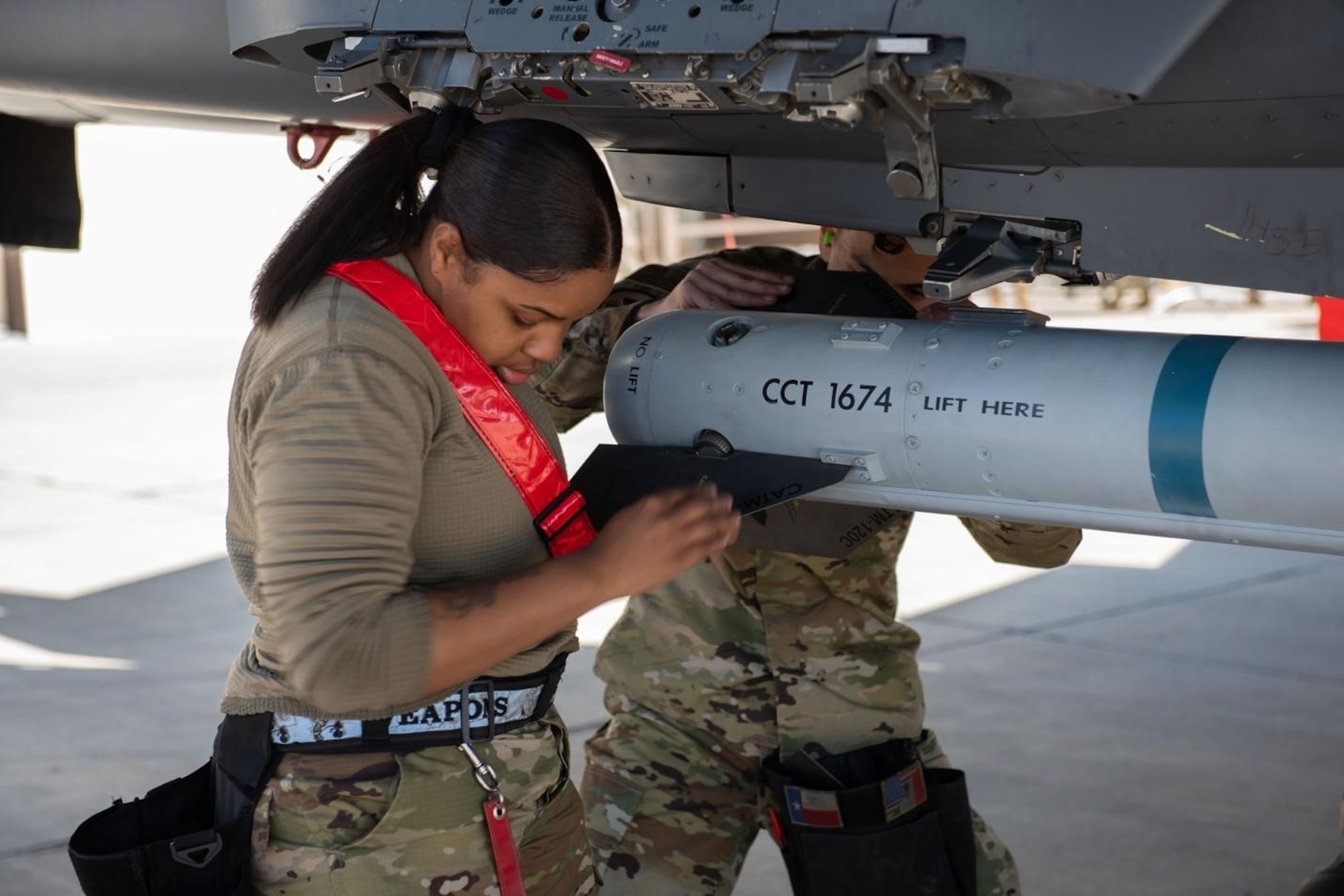 A Airman installs a fin on to an Air Intercept Missile.
